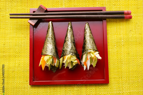 Photo: Temaki-sushi on red platter Temaki-sushi on red platter