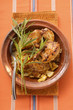 Braised chicken with onions and tarragon in tajine