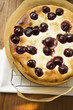 Freshly-baked cherry cake on cake rack
