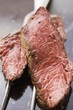 Two slices of beef steak on meat fork