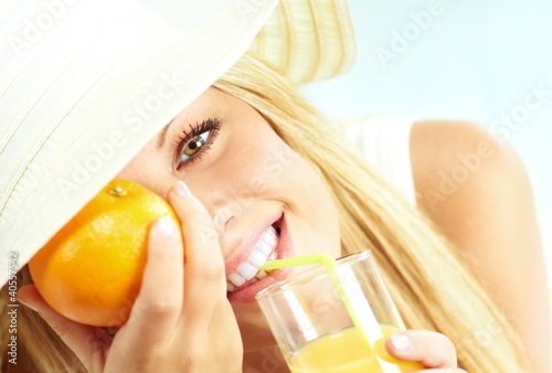 Photo: young blond girl with orange juice young blond girl with orange juice