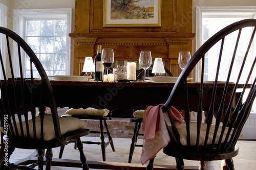 Photo: Laid table with red wine in front of fireplace Laid table with red wine in front of fireplace