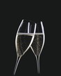 Two glasses of sparkling wine being clinked together