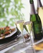 Glasses of sparkling wine, wine bottle, stuffed courgettes
