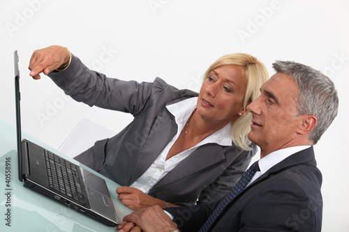 Photo: Colleagues working on a report together Colleagues working on a report together