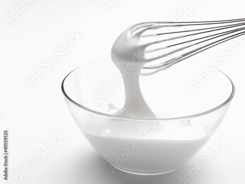 Photo: Whipped cream in bowl with whisk Whipped cream in bowl with whisk