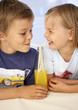 Children drinking orangeade through straws