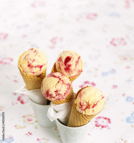 Photo: Scoops of vanilla and raspberry ice cream in cones Scoops of vanilla and raspberry ice cream in cones