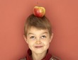 Small boy with apple on his head