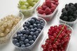 Six plastic punnets of different berries