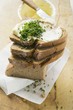 Several slices of bread in a pile with butter and chives
