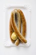 Four sausages with mustard
