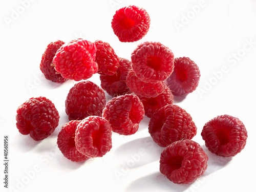Photo: Raspberries falling onto a light surface Raspberries falling onto a light surface