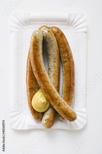 Photo: Four sausages with mustard Four sausages with mustard