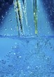 A stream of water falling into water and creating bubbles