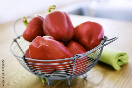 Photo: Red peppers in a wire basket Red peppers in a wire basket