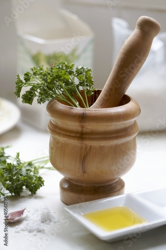 Photo: Wooden pestle & mortar with ingredients for parsley pesto Wooden pestle & mortar with ingredients for parsley pesto