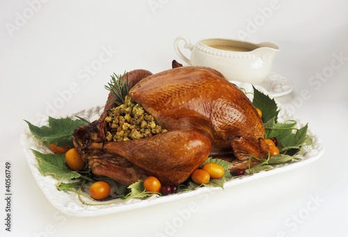 Photo: Stuffed turkey on a platter with gravy boat Stuffed turkey on a platter with gravy boat