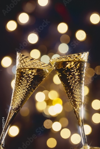 Photo: Two glasses of sparkling wine being clinked together Two glasses of sparkling wine being clinked together