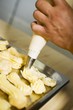 Piping cream onto eclairs with piping bag
