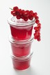 Three jars of redcurrant jelly with fresh redcurrants