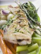 Fried sea bass with pesto on vegetables