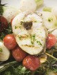 Grilled sea bass cutlet on roasted cherry tomatoes