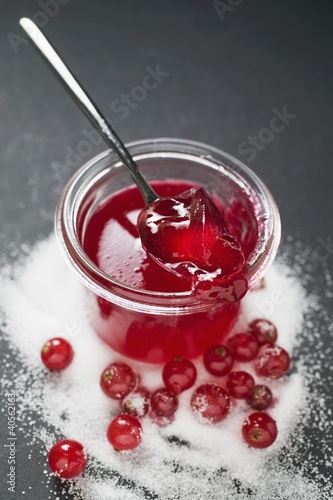Photo: Jar of redcurrant jelly with spoon, sugar and redcurrants Jar of redcurrant jelly with spoon, sugar and redcurrants