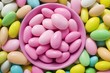 Sugared almonds, in and around pink bowl