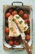 Monkfish with cherry tomatoes and olives in roasting tin