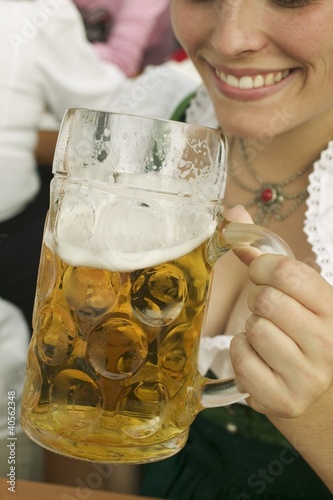 Foto: Woman drinking a litre of beer at Oktoberfest Woman drinking a litre of beer at Oktoberfest