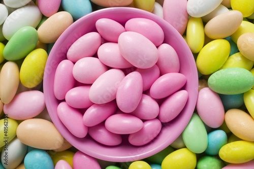 Photo: Sugared almonds, in and around pink bowl Sugared almonds, in and around pink bowl