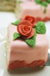 Piece of birthday cake with marzipan roses on cake server