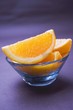 Several orange wedges in glass bowl