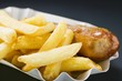 Currywurst (sausage with ketchup & curry powder) & chips in paper dish