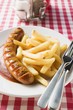 Currywurst (sausage with ketchup & curry powder) & chips in restaurant