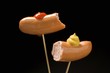 Two half frankfurters with mustard and ketchup