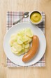 Frankfurter with potato salad, mustard in small dish