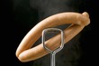 Tongs holding frankfurters