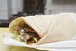 Döner wrap on paper napkin in snack bar