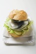 Herring, onions & gherkins in bread roll on paper plate