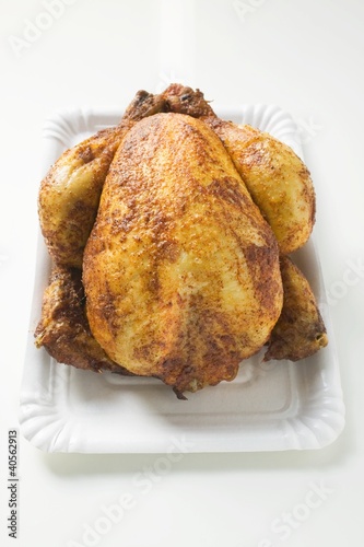 Photo: Whole roast chicken on paper plate Whole roast chicken on paper plate