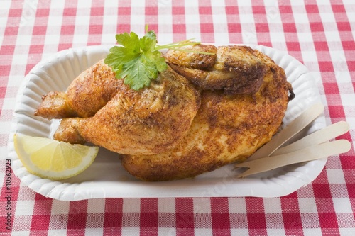 Photo: Half a roast chicken in paper dish Half a roast chicken in paper dish