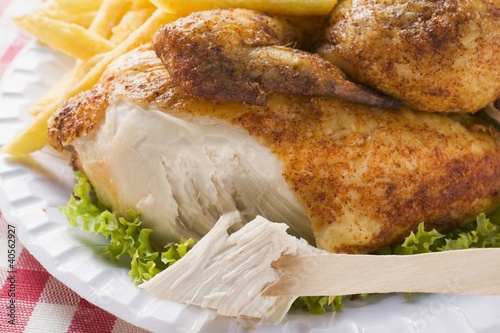 Photo: Half a roast chicken, partly eaten, with chips Half a roast chicken, partly eaten, with chips