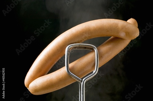 Photo: Tongs holding frankfurters Tongs holding frankfurters