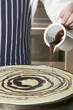 Pouring chocolate onto crêpe