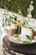 Olives, cheese, crackers & olive oil on table out of doors