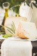 Cheese, green olives and olive oil on table out of doors