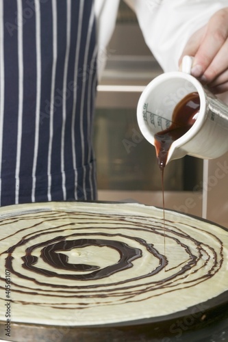 Photo: Pouring chocolate onto crêpe Pouring chocolate onto crêpe