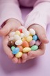 Child's hands holding coloured sugar eggs
